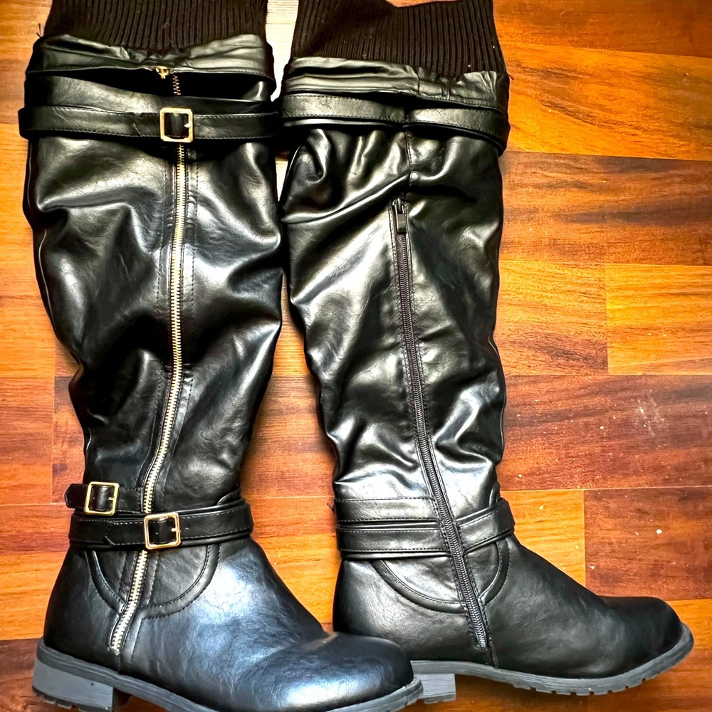 Black leather winter boot with low heel. Size 10. Never worn.